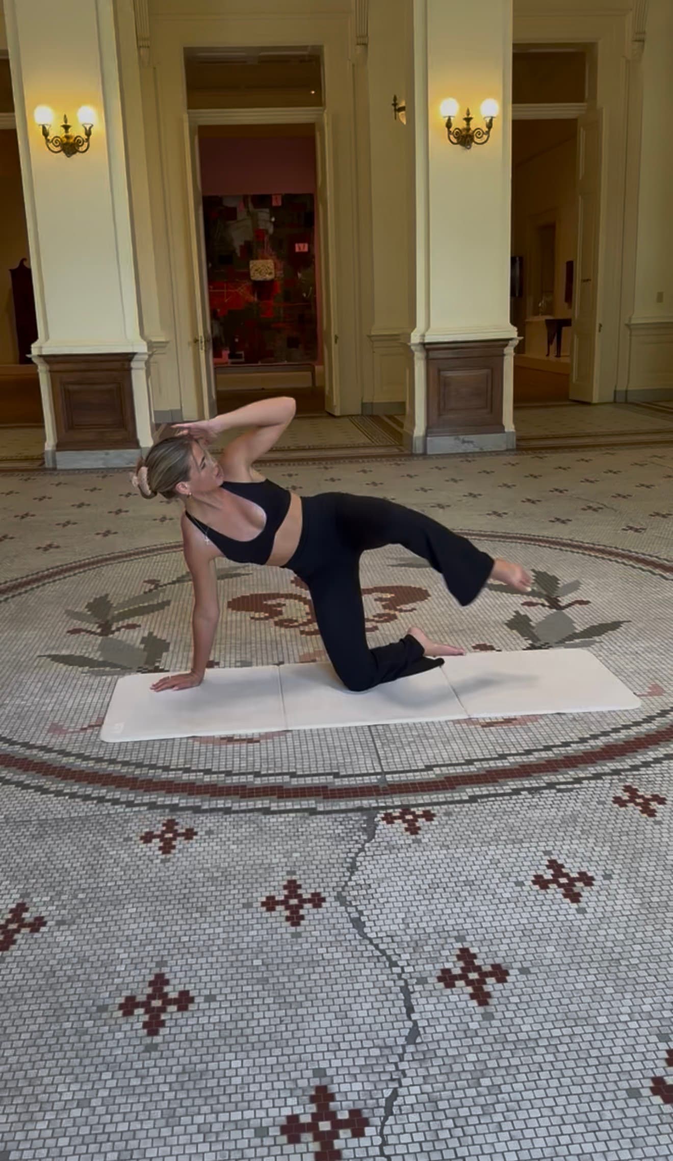 A sculpting Pilates pose in the Gibbes rotunda