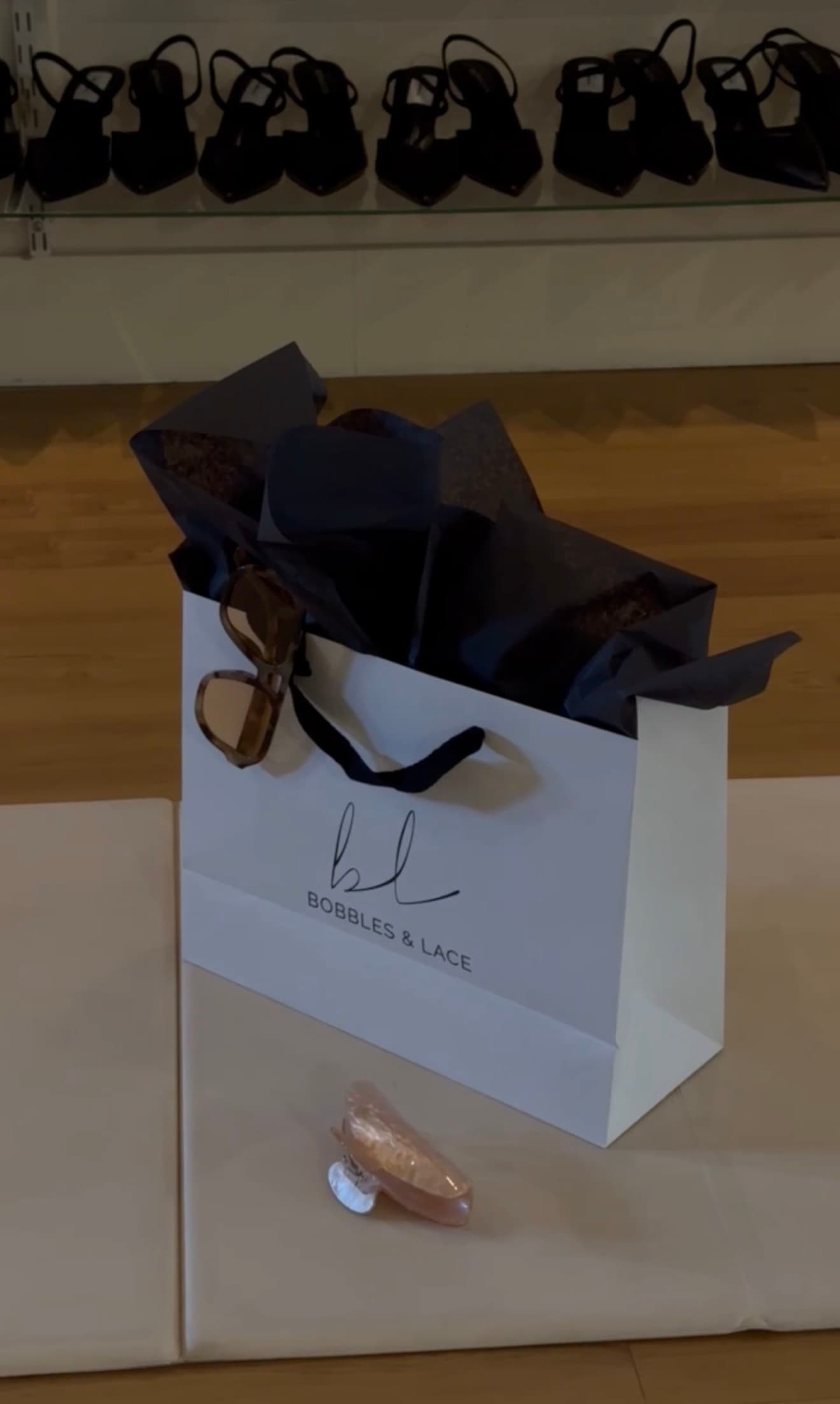 A Bobbles & Lace gift bag with sunglasses from the last Sculpt & Shop